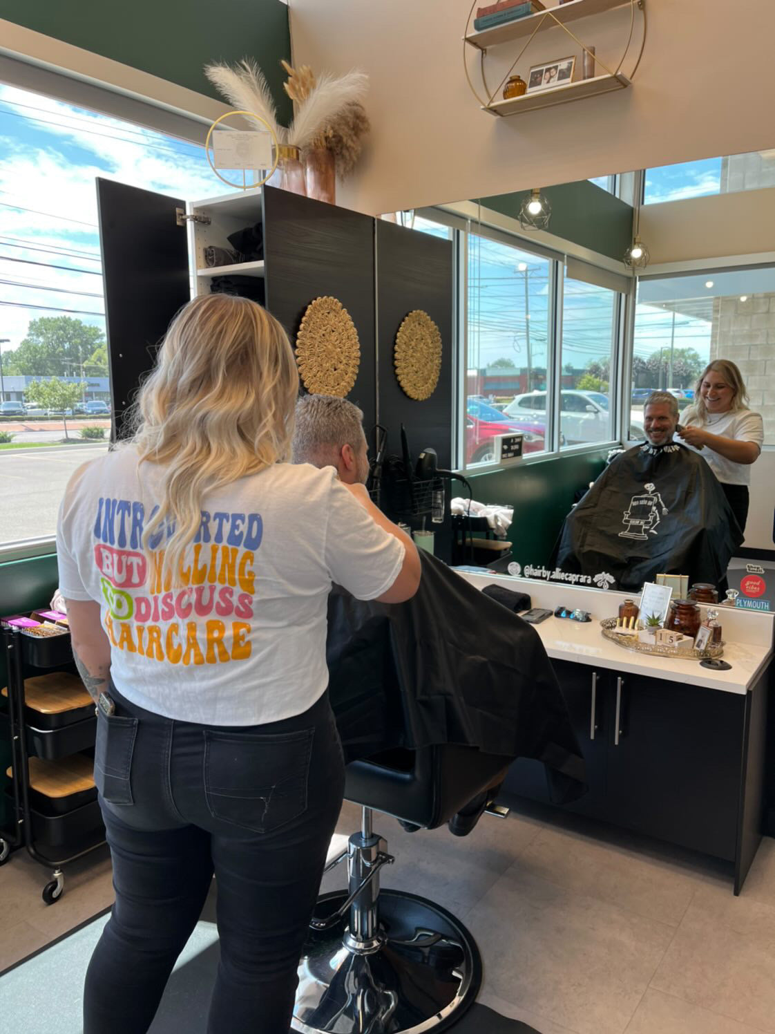 Hair stylist cutting hair in salon wearing ready to dye apparel hair stylist t-shirt